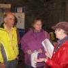 Peter and Val Hawkins listen to Julie Watt's description of the paper-makers' graves in the kirkyard